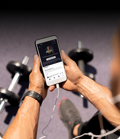 person in a gym listening to leadership podcast